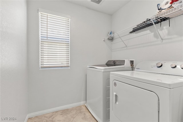 laundry area with light tile patterned floors, washer and dryer, and a healthy amount of sunlight