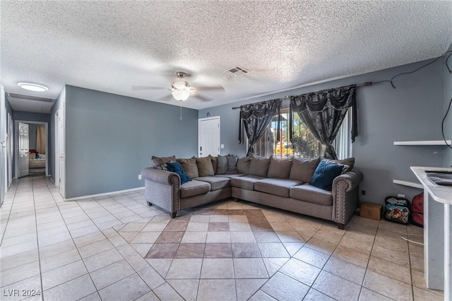 tiled living room featuring ceiling fan and a textured ceiling