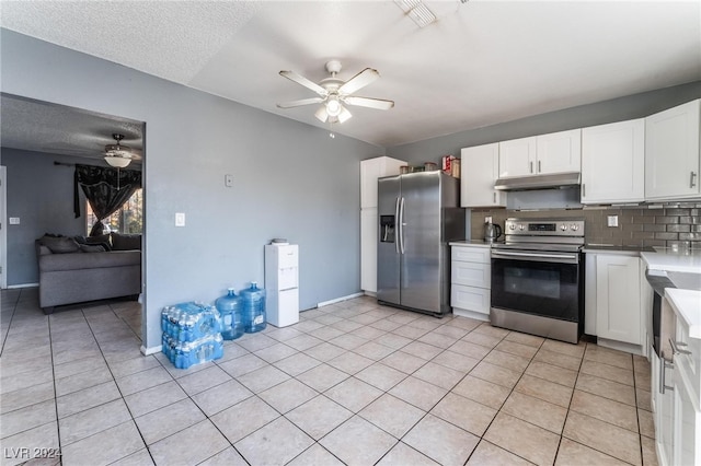 kitchen featuring ceiling fan, white cabinets, stainless steel appliances, and decorative backsplash