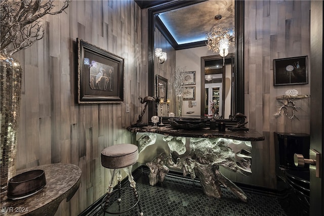 bathroom featuring lofted ceiling and wood walls