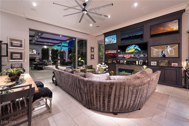 living room featuring ceiling fan, crown molding, and light tile patterned floors