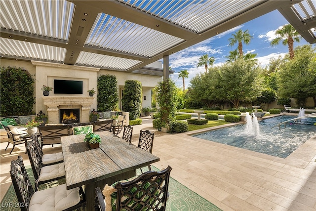 view of patio / terrace with pool water feature and an outdoor fireplace