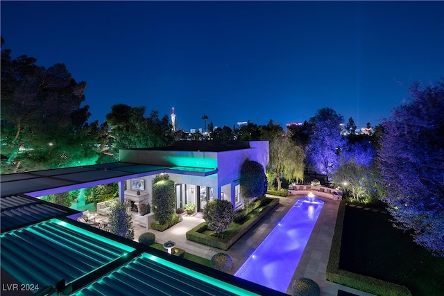 view of pool at night