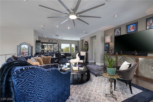 living room featuring ceiling fan and wood-type flooring