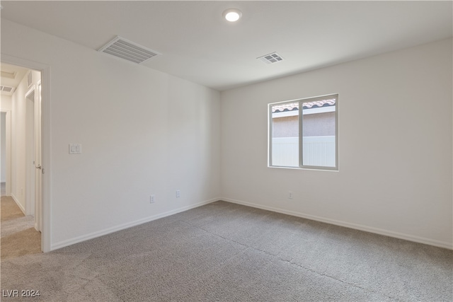 empty room featuring light carpet