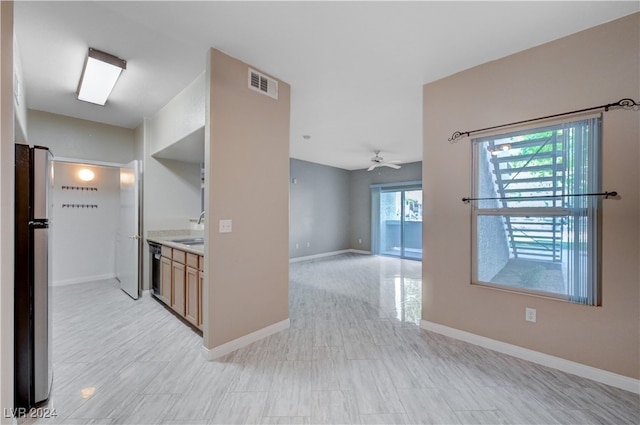 kitchen featuring stainless steel appliances, ceiling fan, and sink