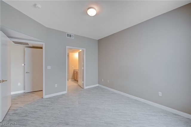 unfurnished bedroom featuring connected bathroom