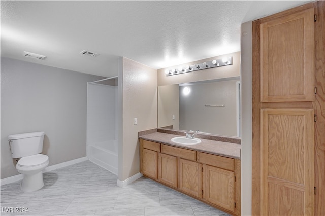 full bathroom with bathtub / shower combination, a textured ceiling, vanity, and toilet