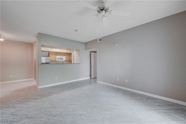 unfurnished living room featuring ceiling fan