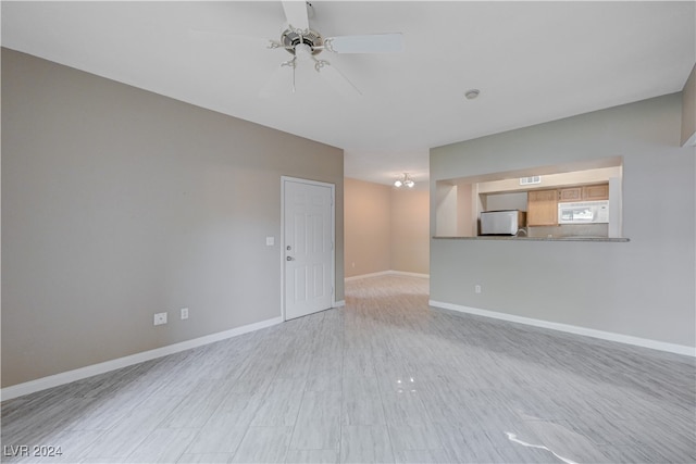 spare room with ceiling fan and light hardwood / wood-style floors