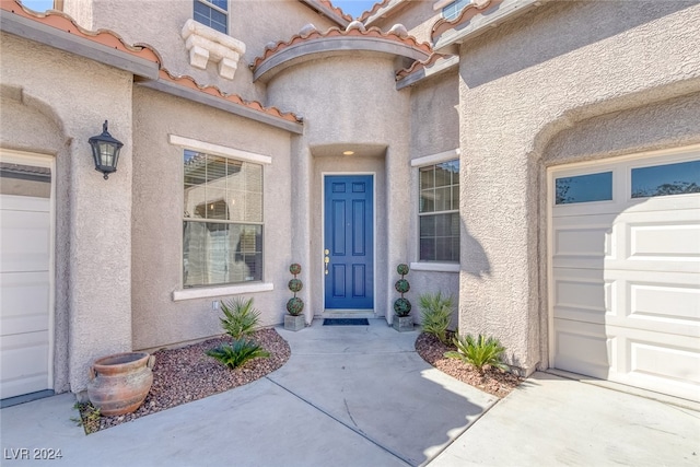 view of exterior entry featuring a garage