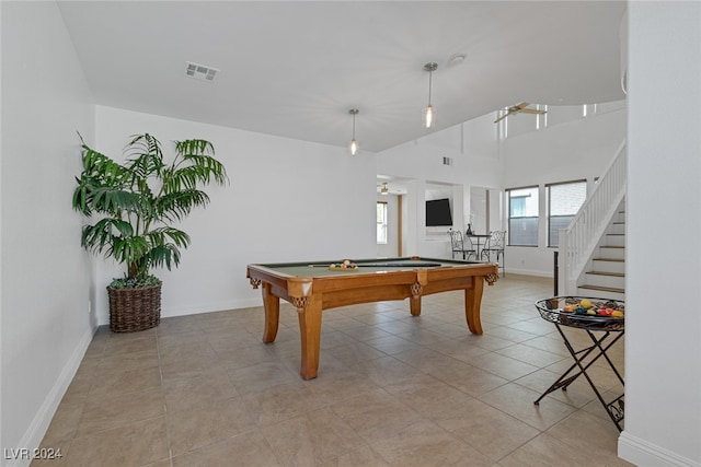 game room with a towering ceiling, light tile patterned floors, and billiards