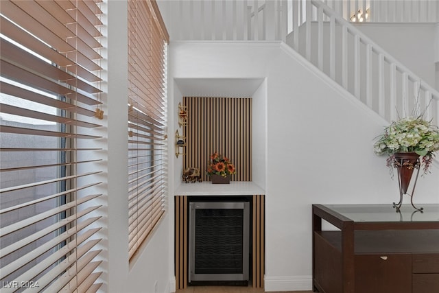 bar featuring a towering ceiling and beverage cooler