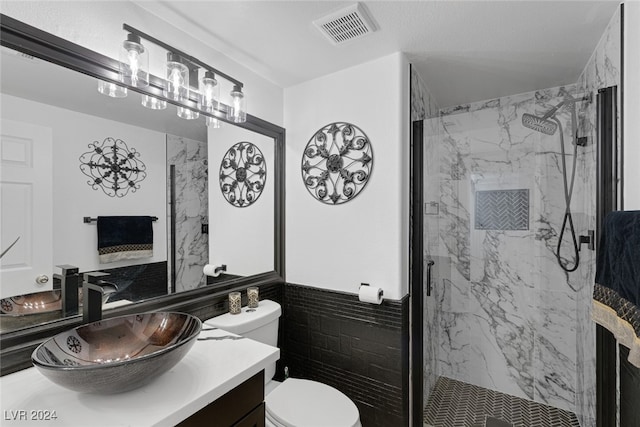 bathroom featuring vanity, toilet, and a shower with shower door