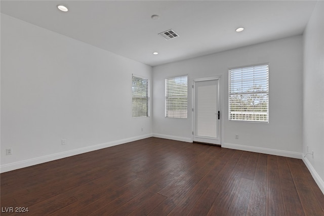 unfurnished room with dark hardwood / wood-style floors