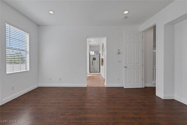 spare room with dark hardwood / wood-style flooring