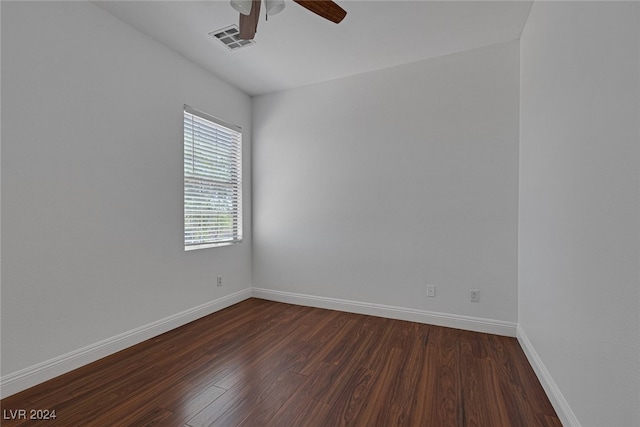 spare room with ceiling fan and dark hardwood / wood-style floors