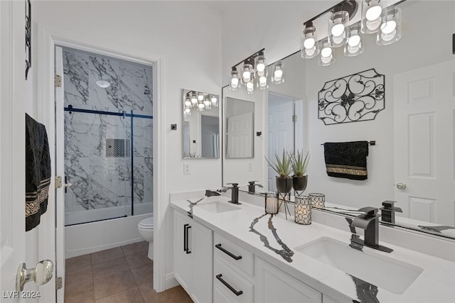 full bathroom with vanity, toilet, combined bath / shower with glass door, and tile patterned floors