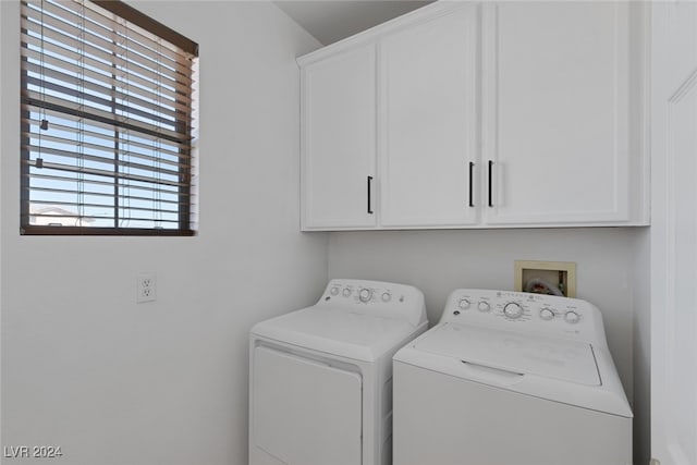 laundry room featuring cabinets and separate washer and dryer