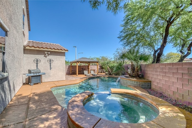 view of pool featuring area for grilling, a patio, an in ground hot tub, pool water feature, and a gazebo