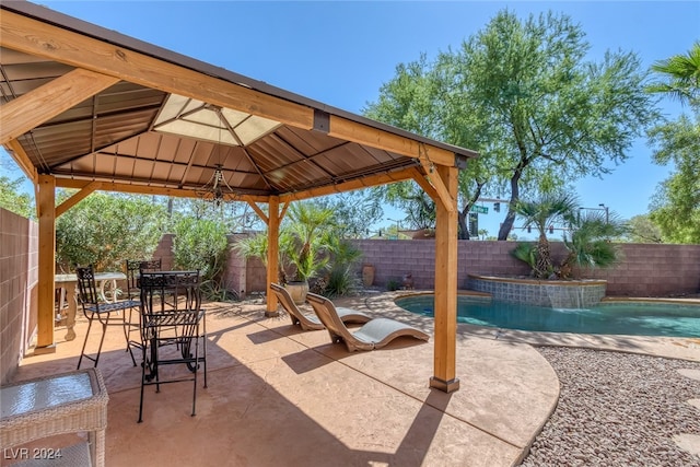 view of patio / terrace with a fenced in pool and a gazebo