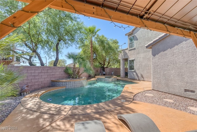 view of swimming pool featuring an in ground hot tub and a patio area