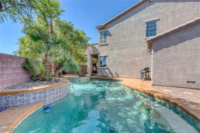 view of swimming pool with a grill and pool water feature