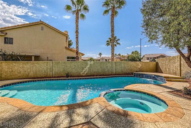 view of pool with an in ground hot tub