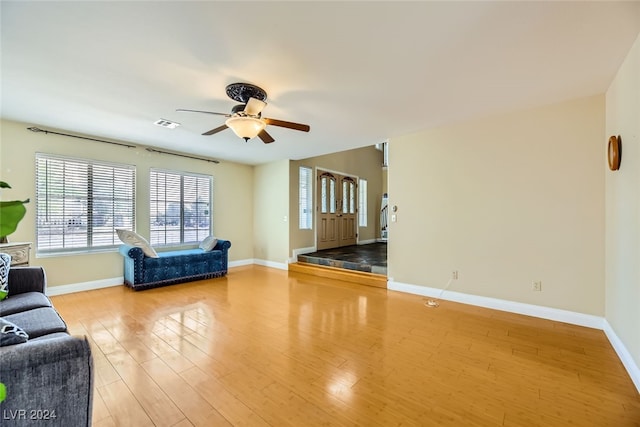 unfurnished living room featuring ceiling fan and light hardwood / wood-style flooring