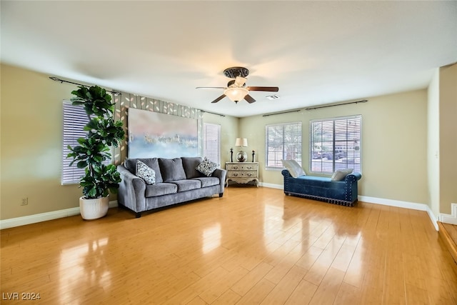 living room featuring light wood-type flooring and ceiling fan