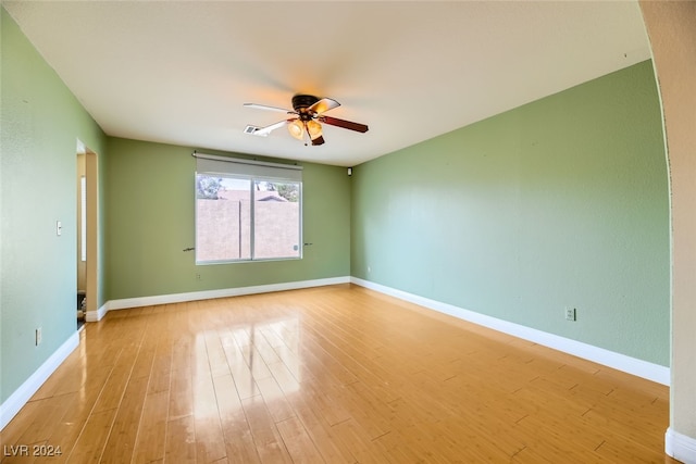 spare room featuring light wood-type flooring and ceiling fan