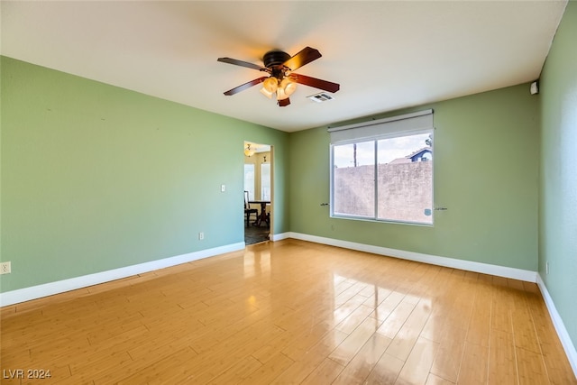 spare room with ceiling fan and light hardwood / wood-style flooring