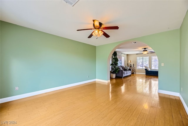 unfurnished room with hardwood / wood-style floors and ceiling fan