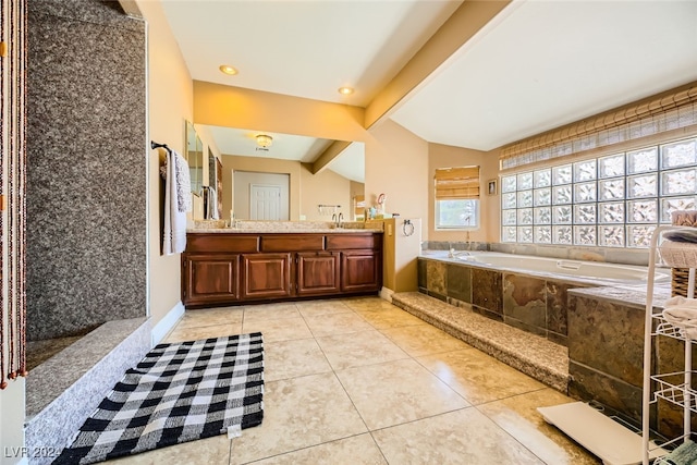 bathroom featuring vaulted ceiling with beams, vanity, tiled bath, and tile patterned flooring