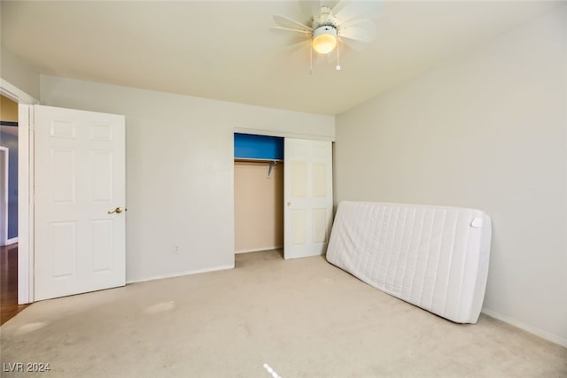 bedroom featuring ceiling fan, a closet, and carpet flooring