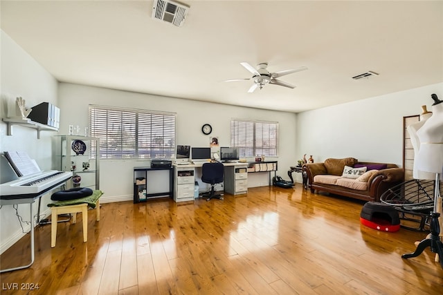 office space featuring plenty of natural light, light hardwood / wood-style floors, and ceiling fan