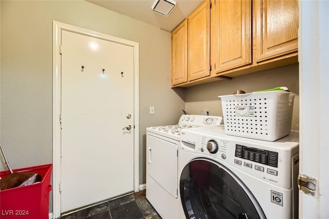 laundry area with washer and dryer and cabinets