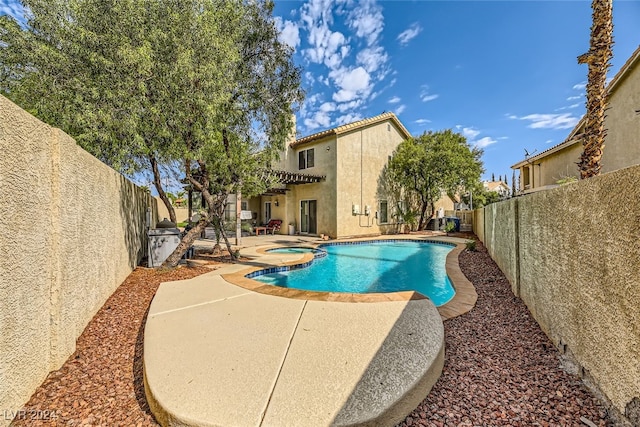 view of swimming pool featuring an in ground hot tub and a patio area