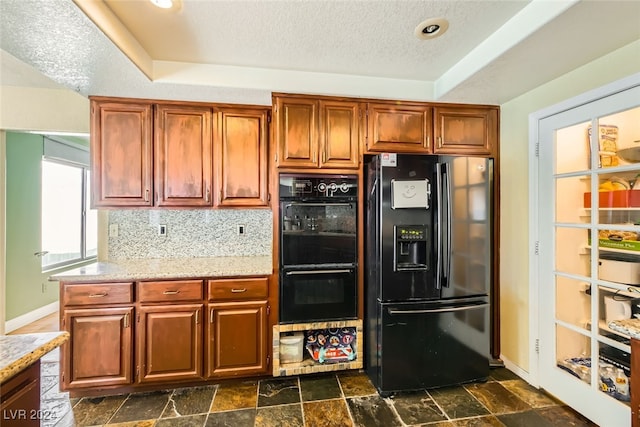 kitchen with decorative backsplash, a raised ceiling, black appliances, and a textured ceiling