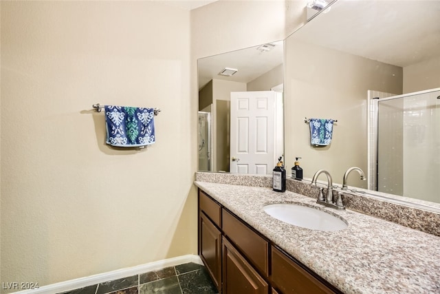 bathroom featuring vanity and a shower with door