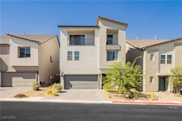 view of front of house featuring central AC unit and a garage