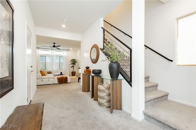 interior space with ceiling fan