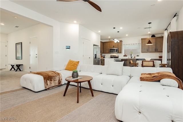 living room featuring ceiling fan and light colored carpet