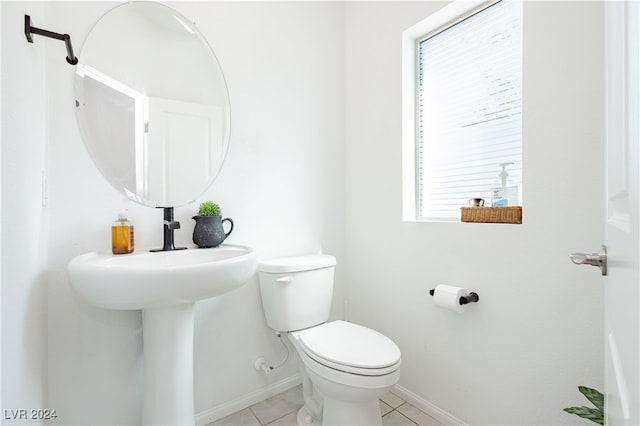 bathroom with tile patterned flooring and toilet