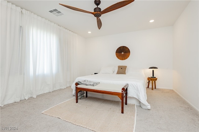 bedroom with light carpet and ceiling fan