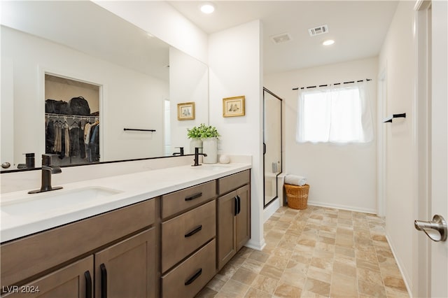 bathroom featuring vanity and an enclosed shower