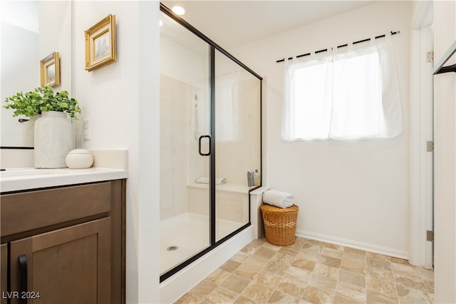 bathroom with walk in shower and vanity