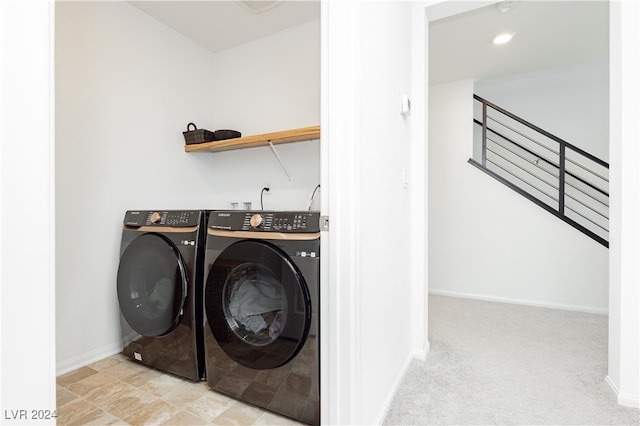 laundry area featuring light carpet and washer and dryer