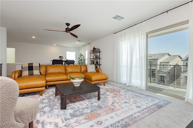 living room with carpet and ceiling fan