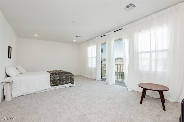 bedroom featuring light colored carpet and access to outside